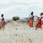 Photo of People Walking on Grassland