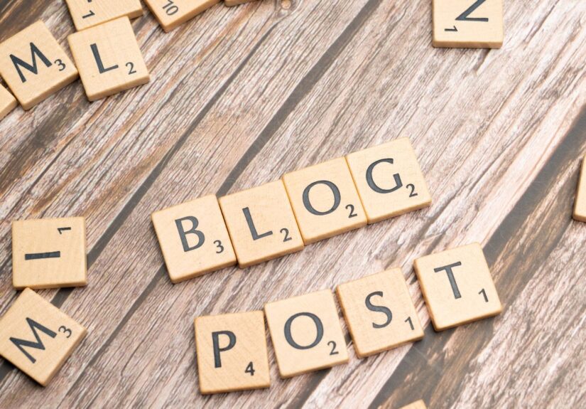 Wooden letter tiles spelling 'Blog Post' on a wooden background, ideal for online media concepts.